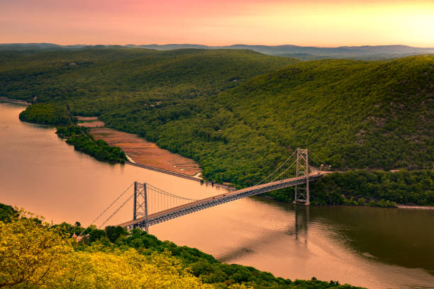Aerial view of Bear Mountain Bridge at sunrise. Aerial view of Bear Mountain Bridge at sunrise. Bear Mountain Bridge is a toll suspension bridge in New York State, carrying U.S. Highways 202 and 6 across the Hudson River hudson valley stock pictures, royalty-free photos & images