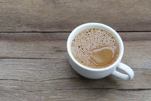 istock Hot coffee in a white Coffee cup on wooden table at coffee shop. 854230406