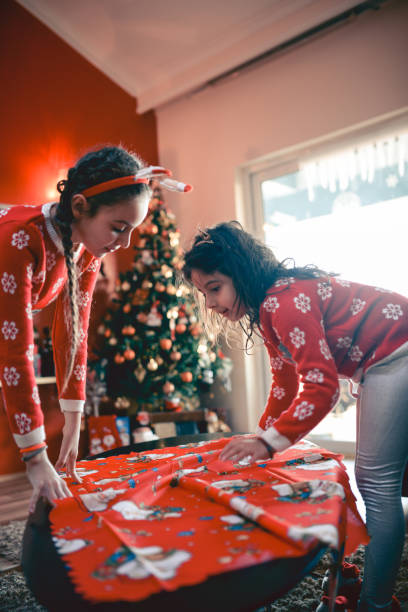 istock Two Little Sisters Decorating their Room for Christmas Holidays 854233056