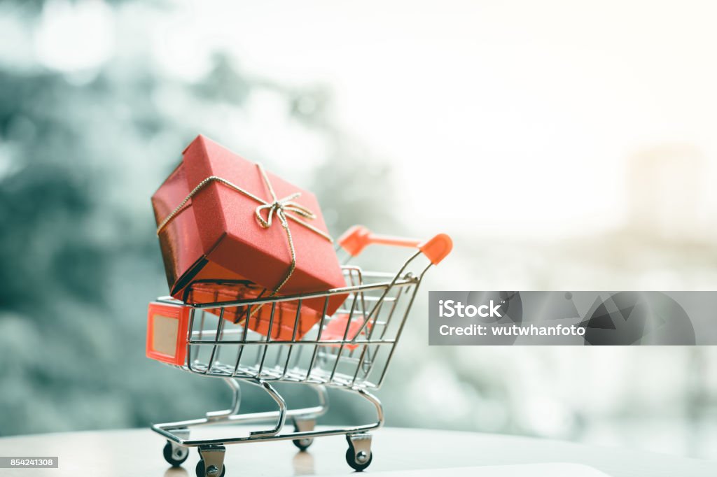 Gift box in small cart about shopping online concept. Incentive Stock Photo