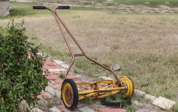 Photo of old manual push lawn mower.