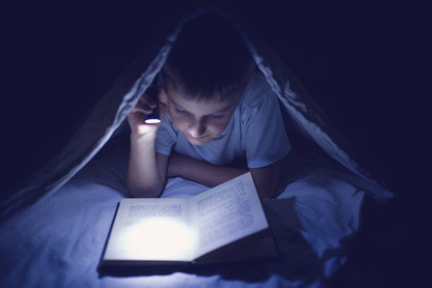 istock Cute little caucasian child, boy, reading book in bed 854243932
