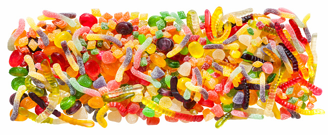 panorama close up a background from colorful sweets of sugar candies and marmalade. assortment candies panoramic view isolated on white background