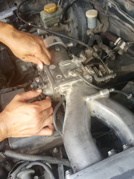 istock Man repairing old engine and checking of a car performance. 854260750