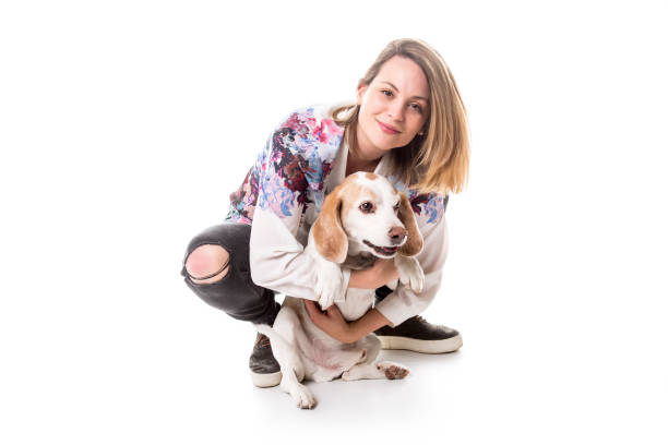 istock Dog with woman are posing in studio - isolated on white background 854261038