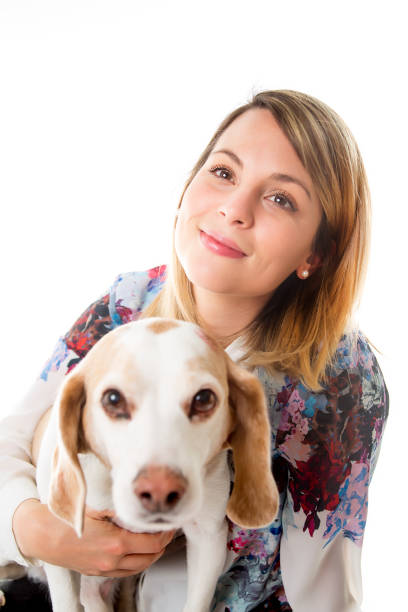 istock Dog with woman are posing in studio - isolated on white background 854261058