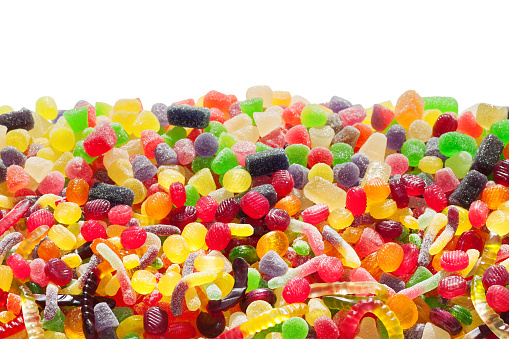 Still life of a variety of candy jars filled with colorful confections.