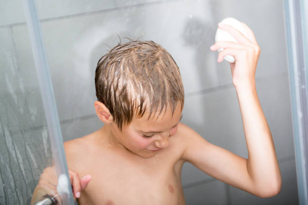 istock Happy young boy wash in shower 854262158