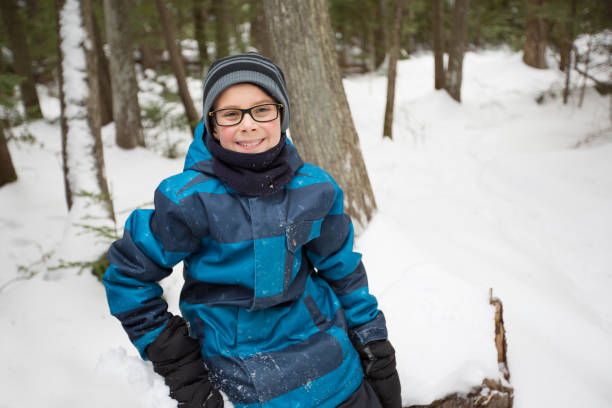 istock Little boy in winter with hat in snow forest 854265552