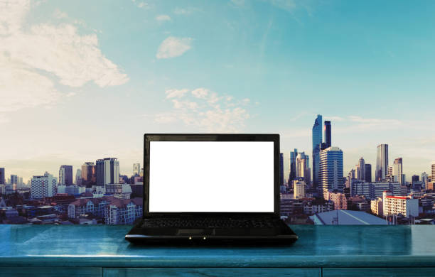 istock Computer laptop on wood table, with Bangkok city view background 854265740