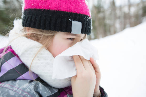 istock child with tissue outside in forest winter season 854265754