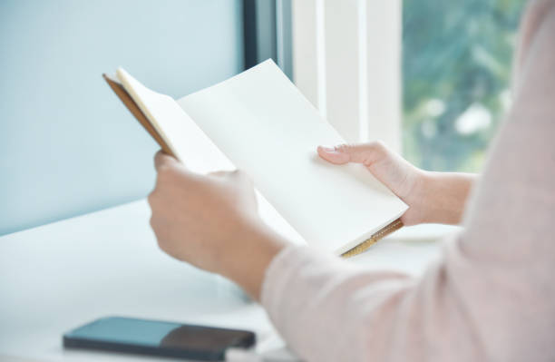istock Happy Asian woman hands holding book. 854269716