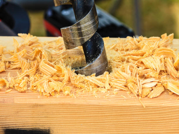 istock Metal machine drilling in wooden board 854276846