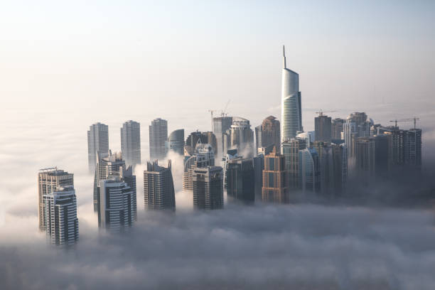 istock Skyscrapers surrounded by heavy fog during a winter morning. 854280392