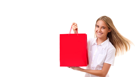 shopping, sale, christmas and holiday-lovely young girl holding red shopping bag, isolated over white background with copyspace