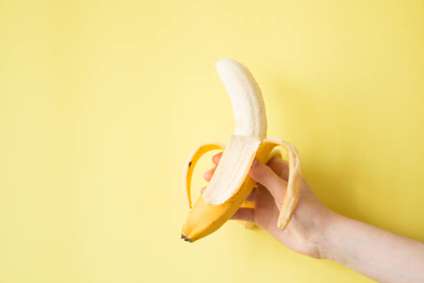 istock Human Hand Holding Banana Fruit Nutrition Concept 854288344