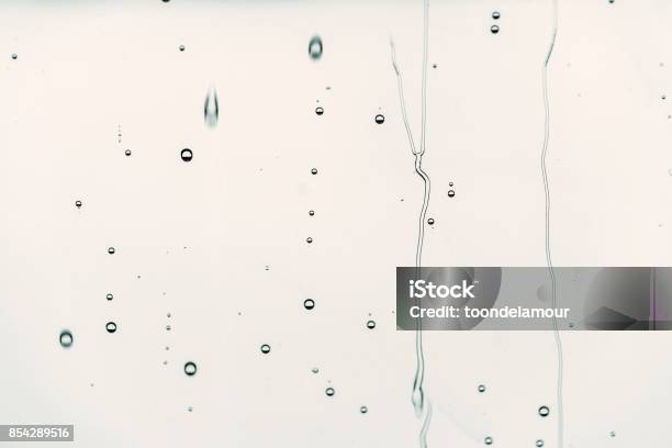 Rain Drops On Glass Flowing Water Background Is Black Color Selective Focus Stock Photo - Download Image Now