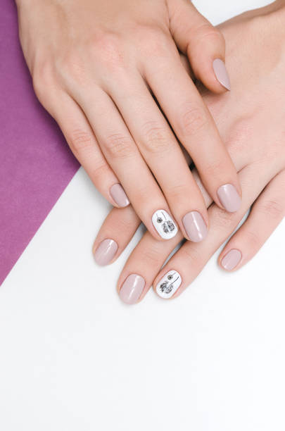 istock Beautiful female hand with dandelion nail design. 854289530