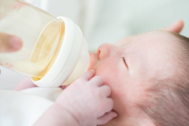 istock Mother feeding baby with milk bottle 854292866
