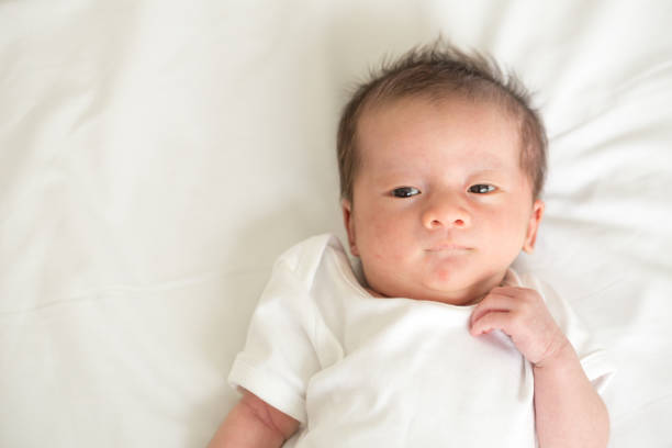 istock Asian newborn baby lying on the bed,Three week old 854292916