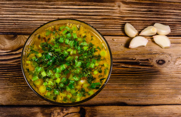 istock Vegetable soup in a glass bowl on wooden table. Top view 854296098