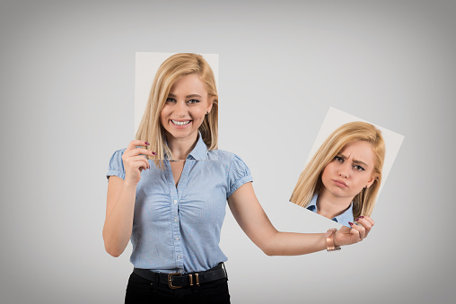 Young woman changing mood from being happy to getting upset and angry