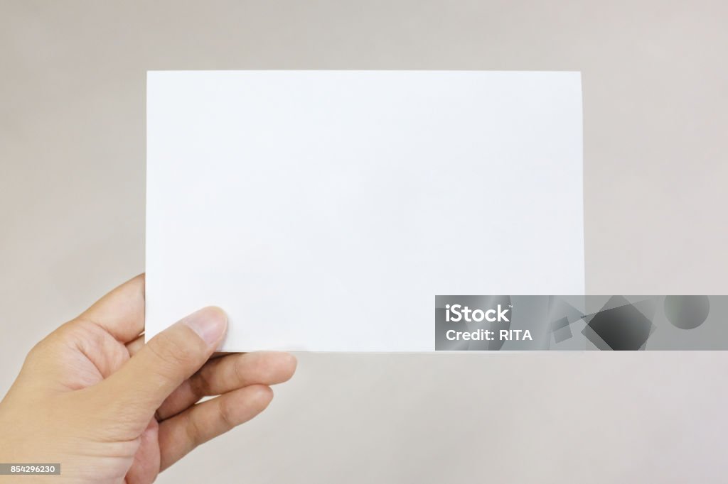 A hand holding a paper card Greeting Card Stock Photo