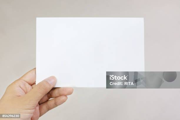 A Hand Holding A Paper Card Stock Photo - Download Image Now - Greeting Card, Human Hand, Holding