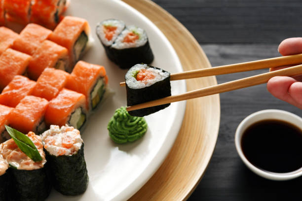 istock Eating sushi and rolls in japanese restaurant 854296296