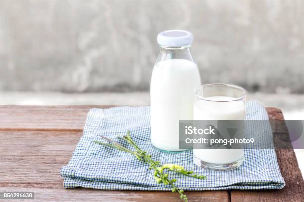 Glass Of Milk And Bottle Of Milk On The Wood Table Stock Photo - Download Image Now