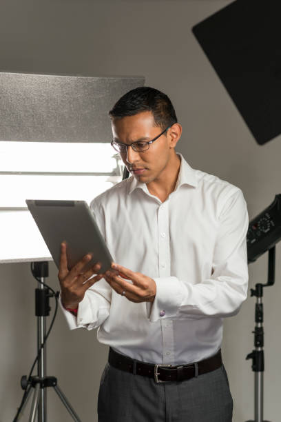 istock Man in Business Suit Staring at Tablet Computer in Studio 854300292