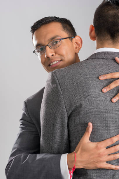 istock Man Embracing Business Partner Isolated in Gray Background 854300430