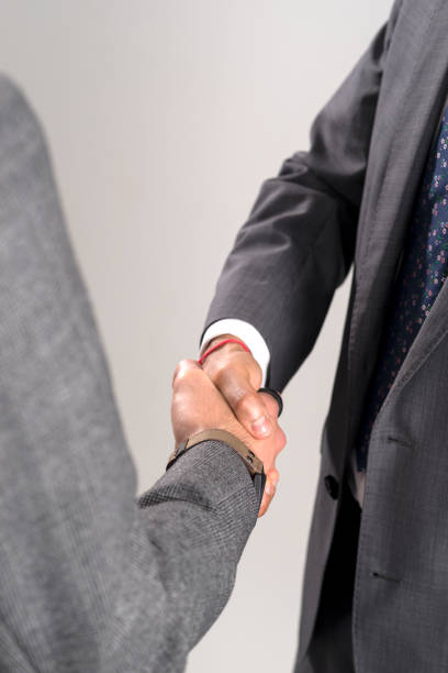 istock Handshake Between Two Business Partners Isolated Over Gray Background 854300456