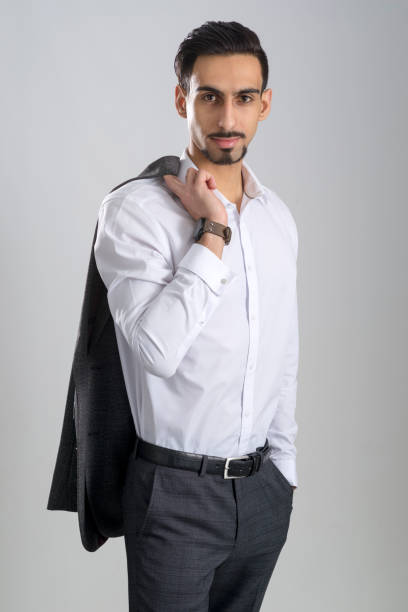 Dark-Haired Bearded Young Man in Collared White Shirt Gray Trousers