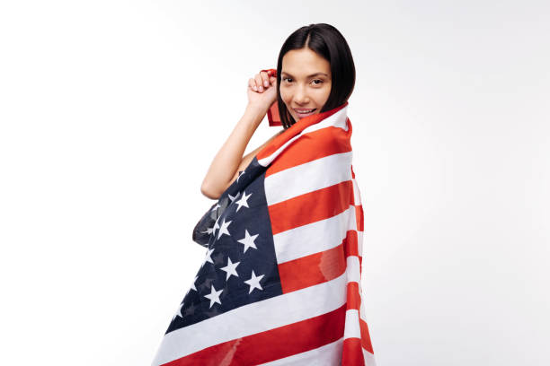 istock Pretty woman posing wrapped in US flag 854303394