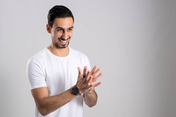 istock Guy in White Shirt Happy and Clapping Hands Copy Space 854303802
