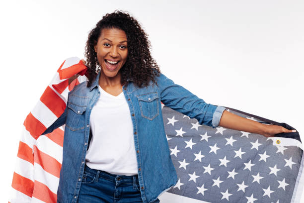 istock Happy woman posing wrapped in American flag 854304028