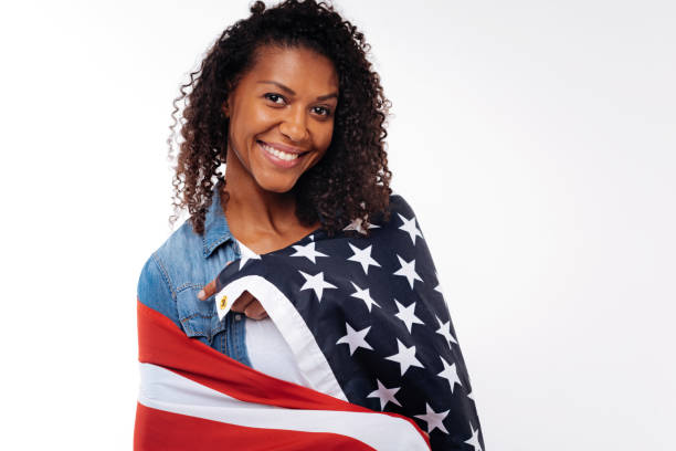 Happy woman wearing US flag on her shoulders