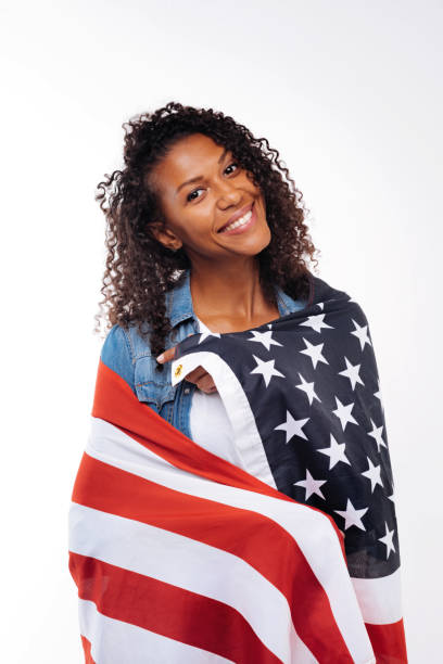 istock Curly brunette posing with American flag 854304150