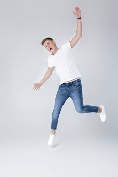 istock handsome man in jeans and jacket jumping 854304408