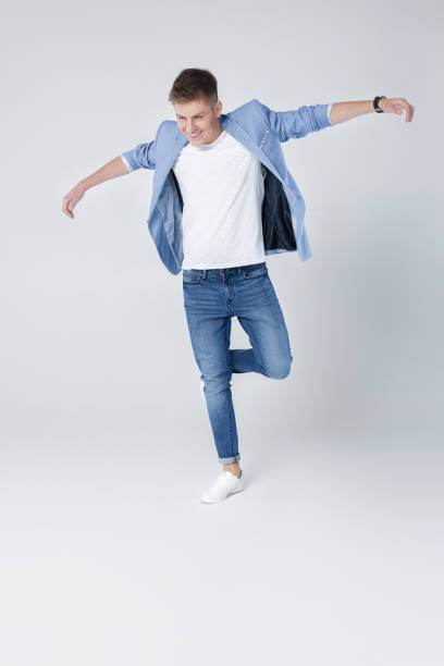istock handsome man in jeans and jacket jumping 854304732