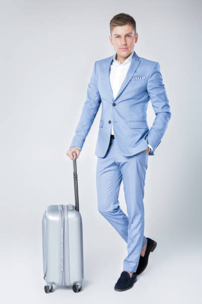 istock young man in blue suit  with suitcase 854304872