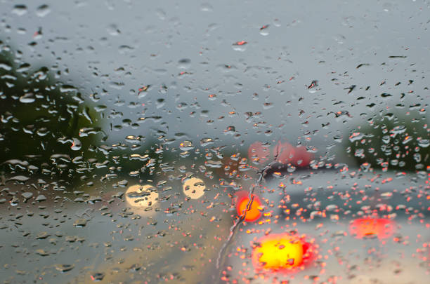 istock Tail Lights in the raindrops of a glass window 854305040