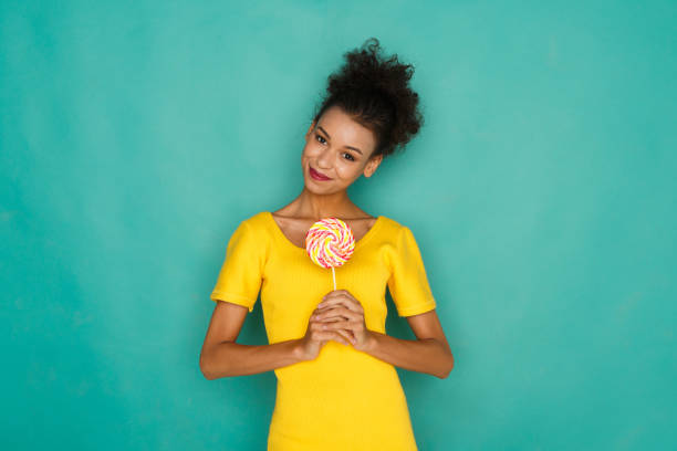 istock Happy girl with lollipop at studio background 854309356