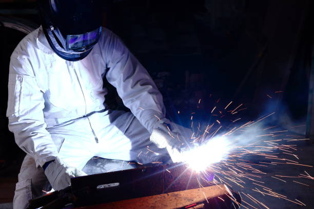 istock Professional welder welding steel with spark in workshop with copy space background. Industrial concept. 854309742