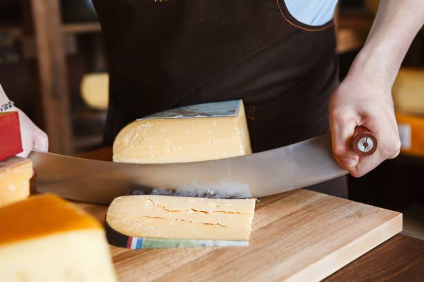 istock Cutting hard cheese in grocery shop 854316340
