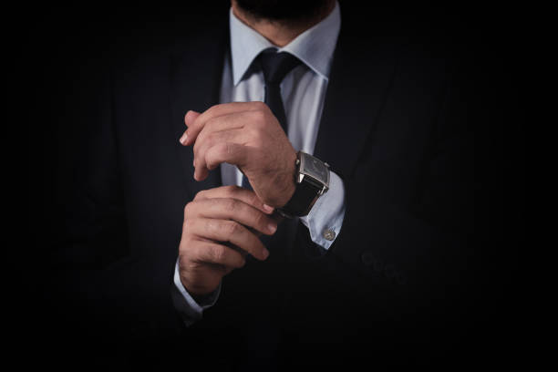 istock Businessman checking time from watch 854319514