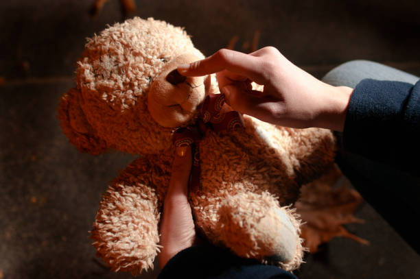 istock Teddy bear in the night park 854319726