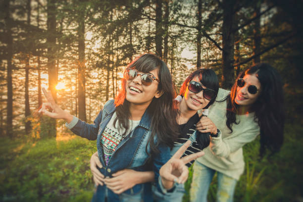 istock Female friends playing and doing fun together in nature. 854326254