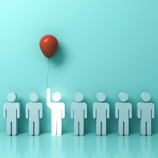 istock Stand out from the crowd and different concept , One glowing light man raising his hand with red balloon among other people on light green pastel background with reflection and shadows . 3D rendering 854329178